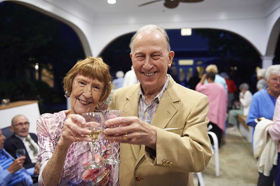 elderly couple toasting