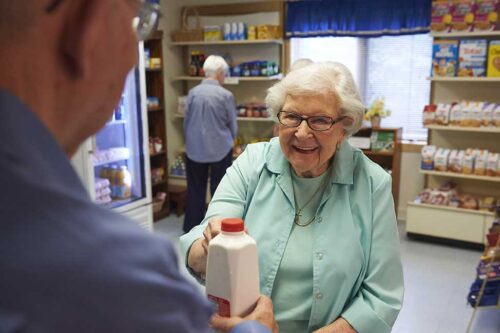 elderly woman checking out at grocery store