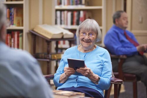 elderly woman using ipad in harrogate library