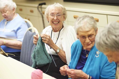 elderly women sewing together